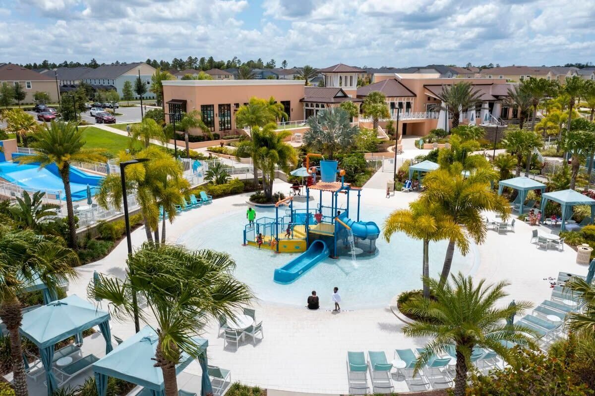 A resort with a water park, palm trees, and a pool area.