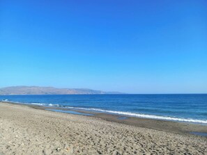 A beach with a clear sky and calm sea.