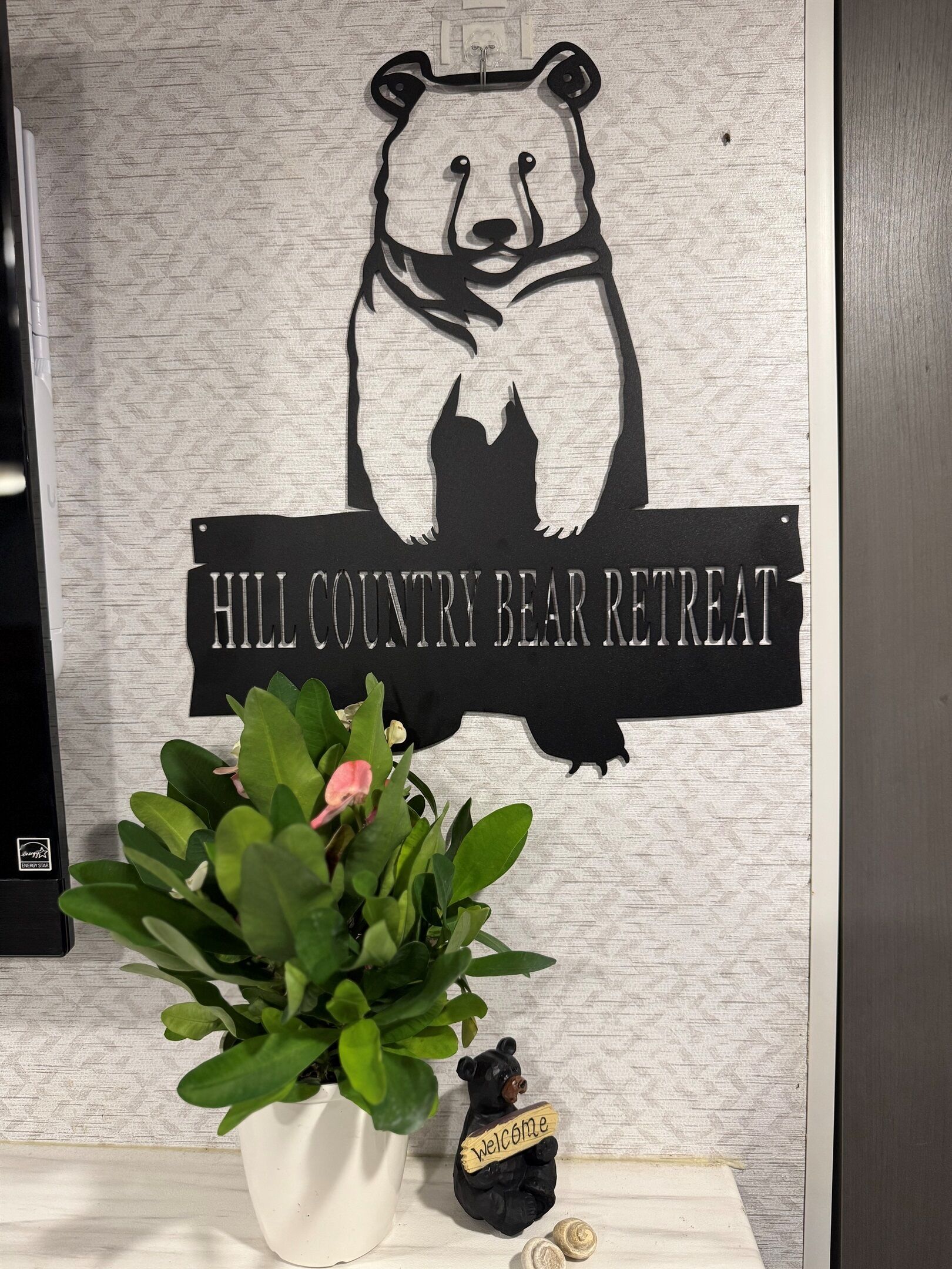 A wall with a bear silhouette and the text "HILL COUNTRY BEAR RETREAT".