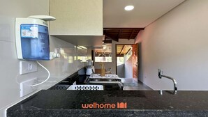 A modern kitchen with a built-in water dispenser, a sink, and a stove.