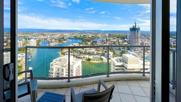 A balcony with a view of a cityscape, including a river and buildings. - Level 30 Renovated Apt with Hot Tub & Netflix (Surfers Paradise)