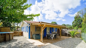 A wooden house with a patio, a pool, and a fenced garden area. - Caban'Océan, the ideal way to discover the Landes Coast between Sea Spray and Pines (Vielle-Saint-Girons)