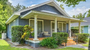 A two-story house with a covered porch, a small front yard, and a staircase leading to the entrance. - Home w/ Private Yard < 2 Mi to Hollis Garden! (Lakeland)