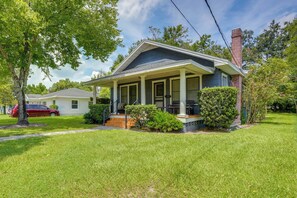 A two-story house with a front porch, a brick chimney, and a well-maintained lawn. - Home w/ Private Yard < 2 Mi to Hollis Garden! (Lakeland)