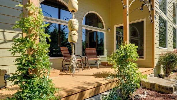 A covered patio with outdoor furniture and a stone pathway leading to the house. - On Mckenzie River! Home w/ Scenic Sunroom (Vida)