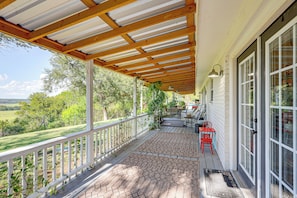 A covered porch with a wooden ceiling, a white railing, and a view of a green landscape. - Boqsue River Valley Views! 3-acre Country Home (Valley Mills)