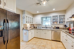 A kitchen with white cabinets, a stainless steel refrigerator, a dishwasher, and a window providing natural light. - Boqsue River Valley Views! 3-acre Country Home (Valley Mills)