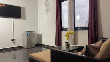 Junior Suite, Balcony, City View | Living area | 80-inch Smart TV with satellite channels, MP3 dock