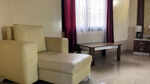 Comfort Bungalow | Living area | 80-inch Smart TV with satellite channels, MP3 dock