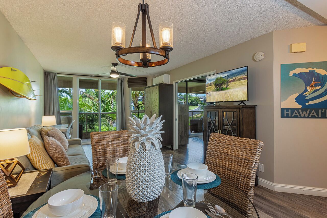 A dining area with a round table, chairs, and a pineapple centerpiece.