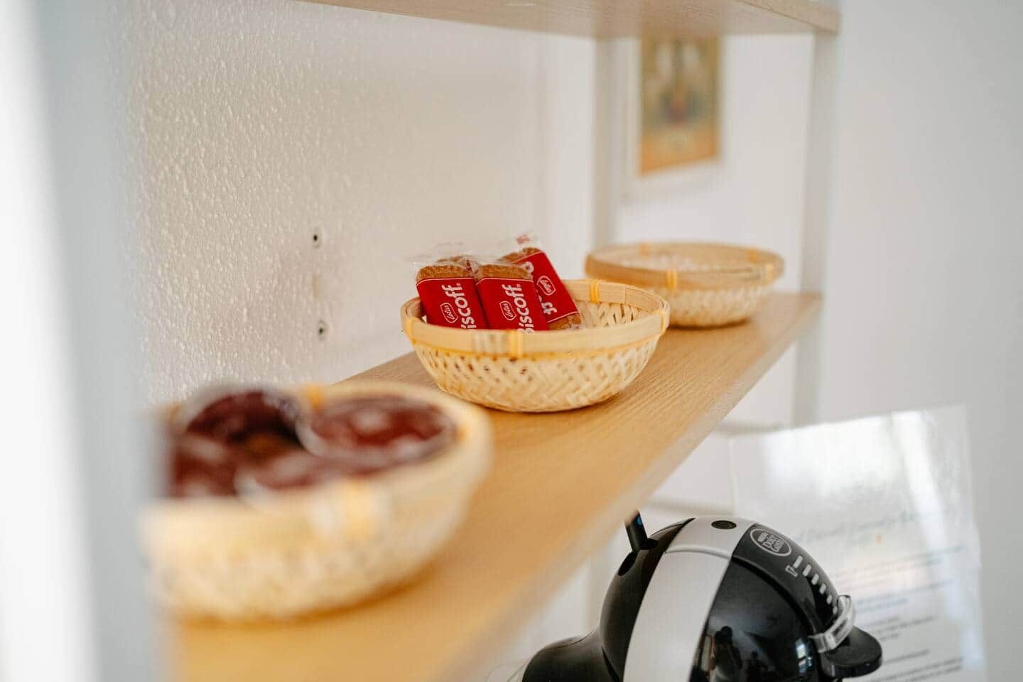 A shelf with baskets containing packaged food items.