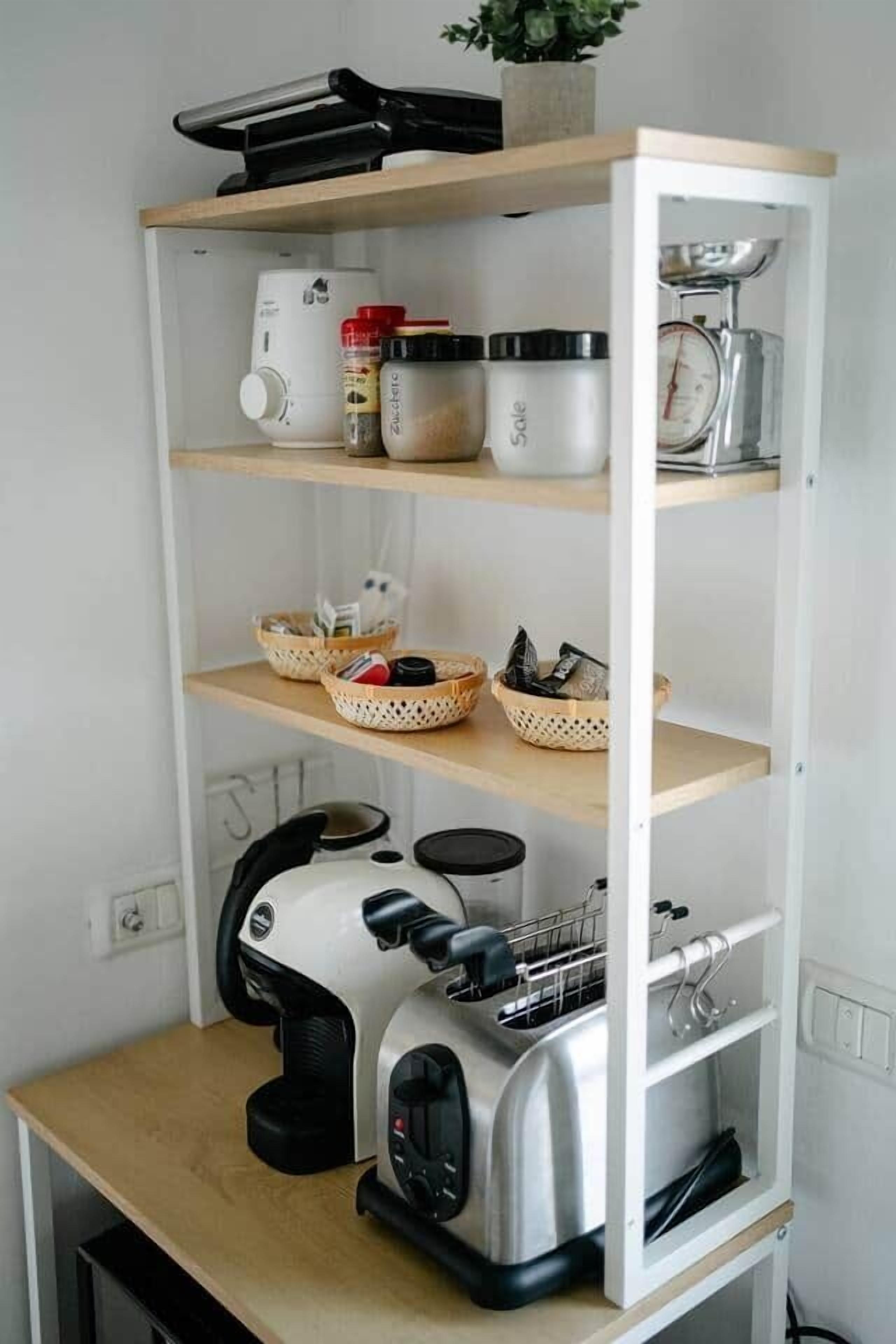 A kitchen with a built-in toaster, a coffee maker, and a scale on the countertop.
