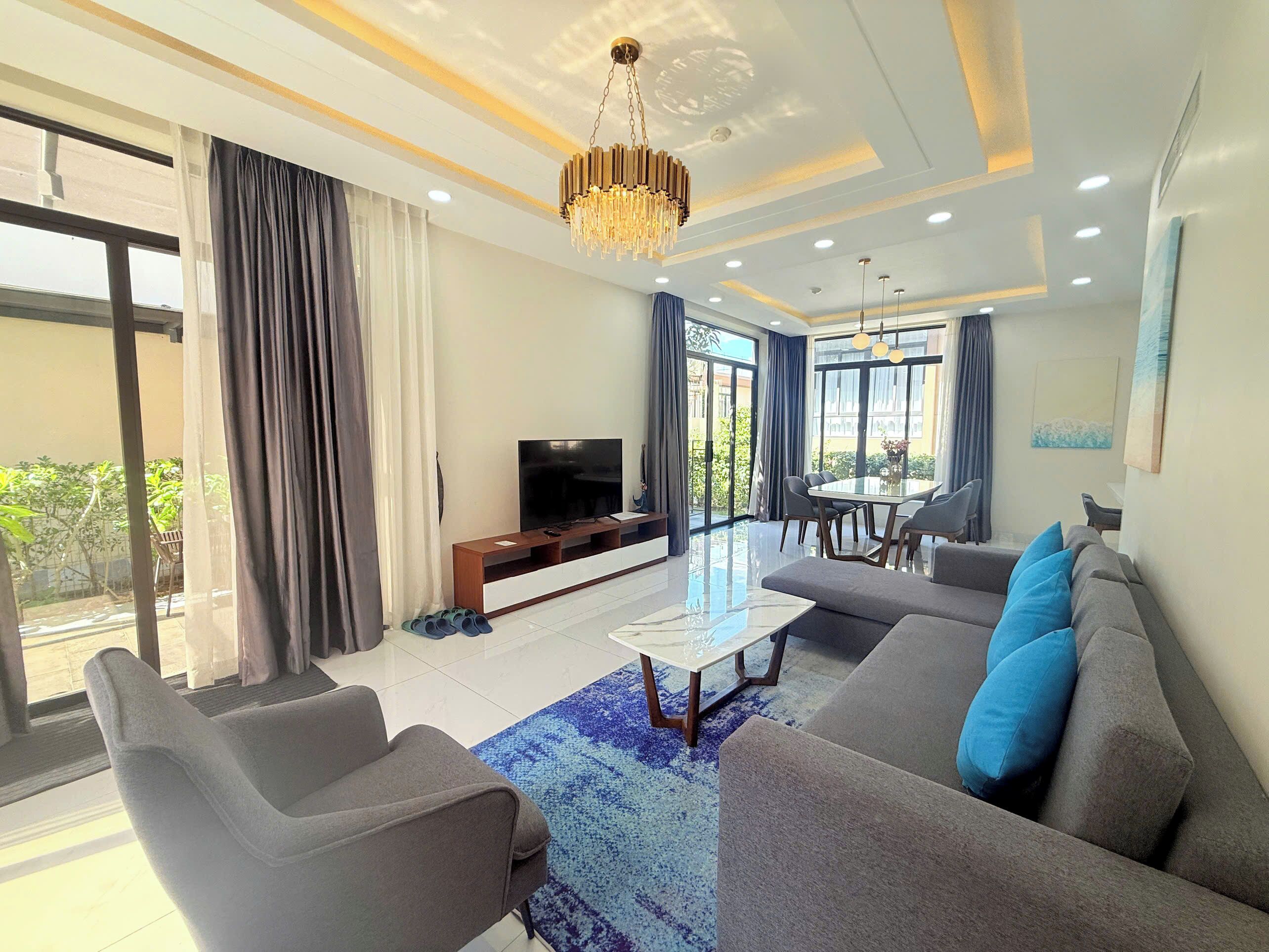 Deluxe Villa, Beachside | Living area | 65-inch flat-screen TV with digital channels