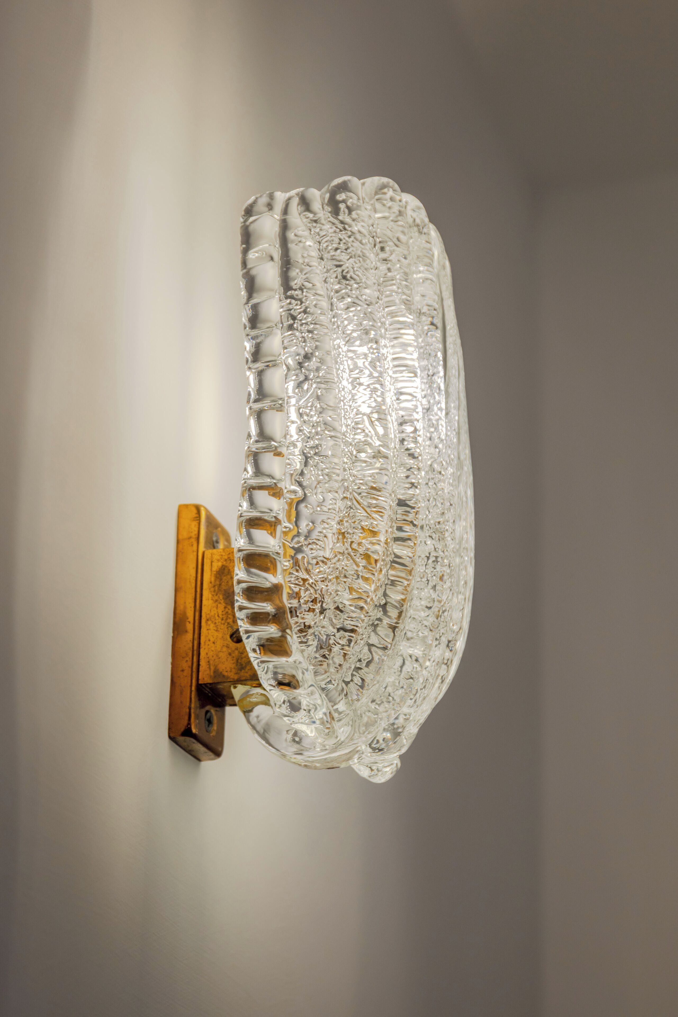 A wall-mounted glass fixture with intricate patterns.