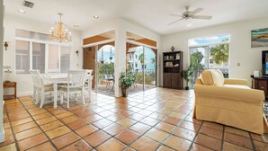 A spacious living area with a dining table, chairs, a sofa, and a ceiling fan. - Beautiful Townhouse 1/2 Block From Siesta key Village & The Beach! (Siesta Key)