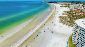 An aerial view of a beach with a hotel adjacent to it. - Stunning Condo at Crystal Sands on Siesta Key! (Siesta Key)
