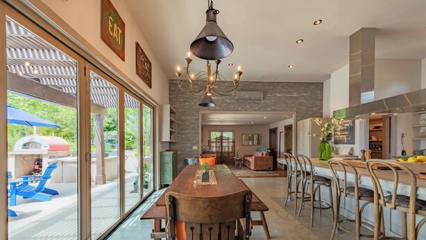 A spacious kitchen with a central island, bar stools, and a chandelier. - 2 Culinary Suites in the heart of Wine Country! (Paso Robles)