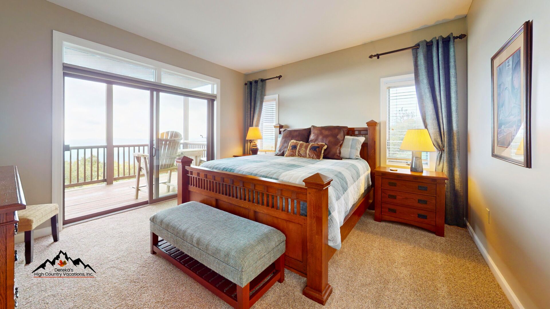 A bedroom with a large bed, a wooden bench, a nightstand, and a view of the outdoors through a sliding glass door.