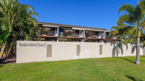 A modern building with a sign reading "Rainbow Surf".