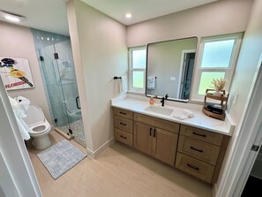 Shower, hair dryer, towels, toilet paper