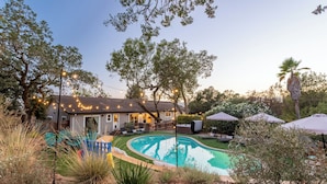 A backyard with a swimming pool, outdoor furniture, and string lights. - Luxury 6-Sleeper: Pool, HotTub, 8 mins to Sonoma Square, and Deluxe Coffee Bar! (Sonoma)
