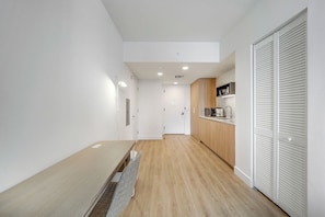 A modern kitchen with wooden cabinets, a microwave, and a sink.