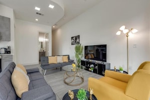 Deluxe Apartment, Balcony, City View | Living area | Computer monitors