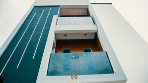 A modern building with a flat roof, large windows, and a logo at the bottom. - Akoka Oasis 1-Bed Near Unilag (Lagos)