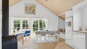 A modern kitchen with white cabinets, a built-in oven, and a refrigerator with a digital interface. - Peaceful cottage in scenic surroundings (Tarm)
