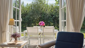 An outdoor seating area with a table, chairs, and a lamp. - Peaceful cottage in scenic surroundings (Tarm)