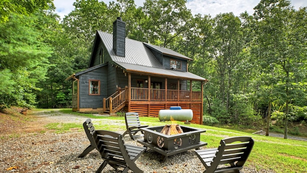 A cabin with a deck, a fire pit, and outdoor seating. - Bigfoot's Solitude | Game Room | Outdoor Firepit | Grill (Morganton)