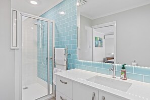 Shower, hair dryer, towels, soap