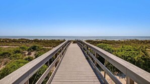 A wooden boardwalk leading to a beach with clear skies. - Ocean Place 12 ~ Wave Watcher (Fernandina Beach)