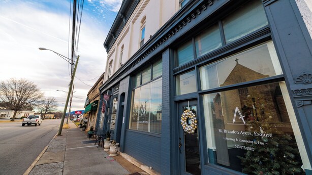 A building with large windows and a door with a wreath, indicating a professional establishment. - Salem Boutique Downtown 3BDRM Suite (Salem)