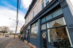A building with large windows and a door with a wreath, indicating a professional establishment. - Salem Boutique Downtown 3BDRM Suite (Salem)