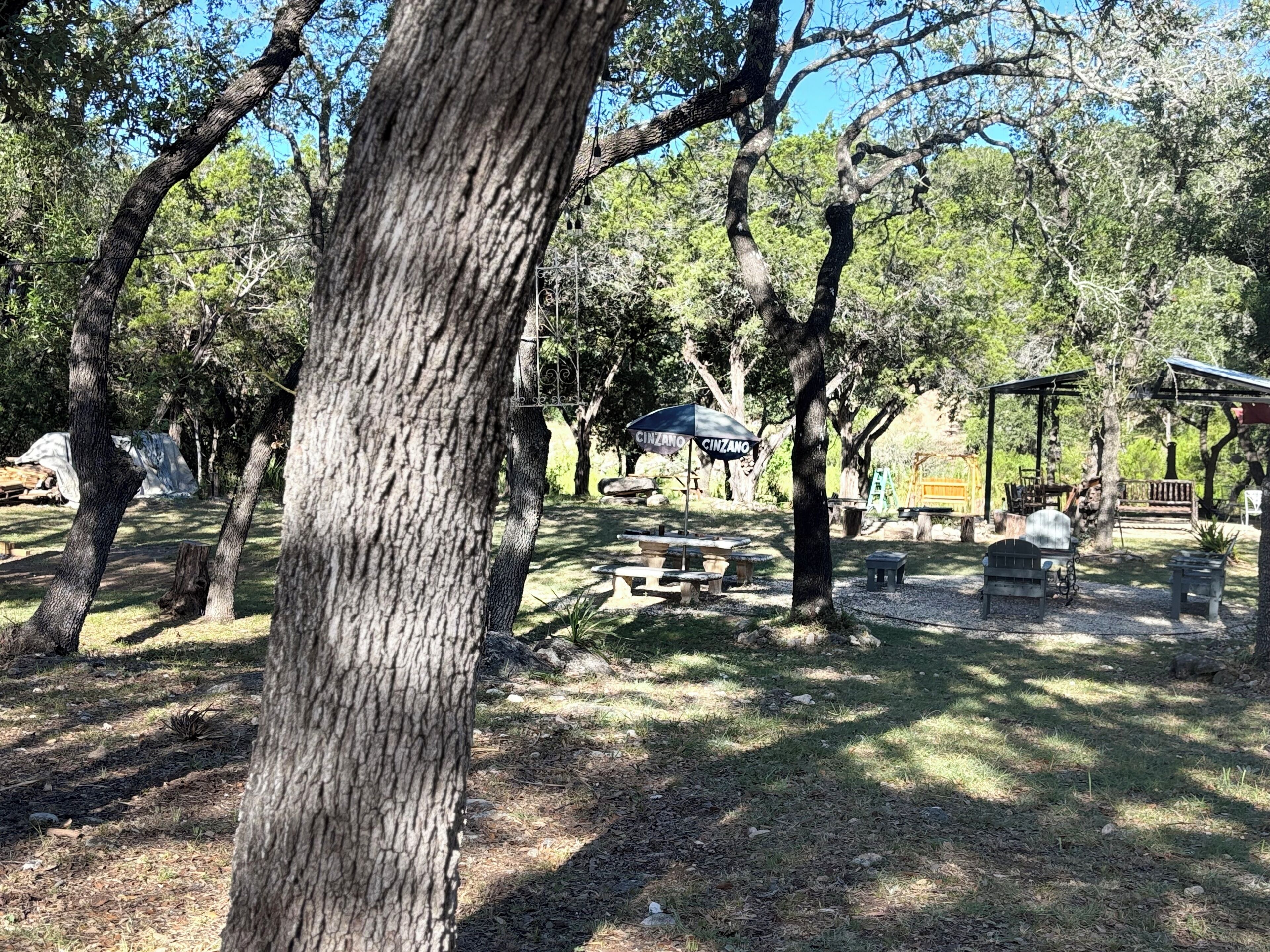 A campground with picnic tables, a covered picnic area, and a playground.