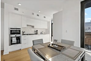 Coffee/tea maker, fridge, microwave, oven - Shaw 2BR | Corner City Views & Garage Parking (Washington)