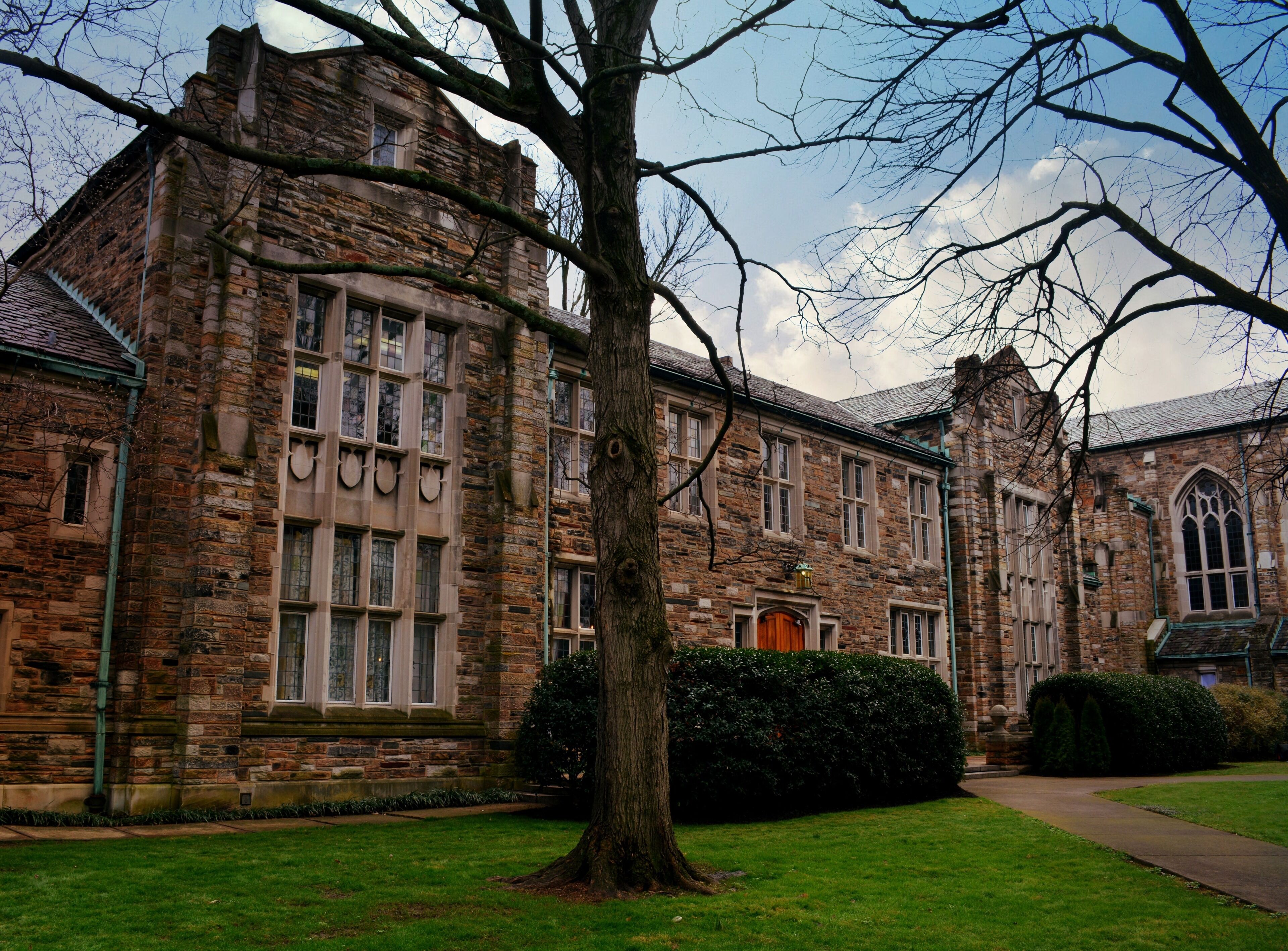 A historic stone building with multiple windows and a central entrance.