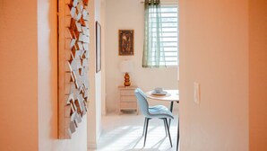 A room with a dining table, chairs, a lamp, and a window with curtains. - Casa Lotus「UNIT 2「Tembleque」 (San Juan)