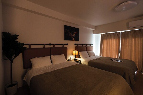 Family Room, Balcony, City View | Laptop workspace, blackout drapes, iron/ironing board, free WiFi