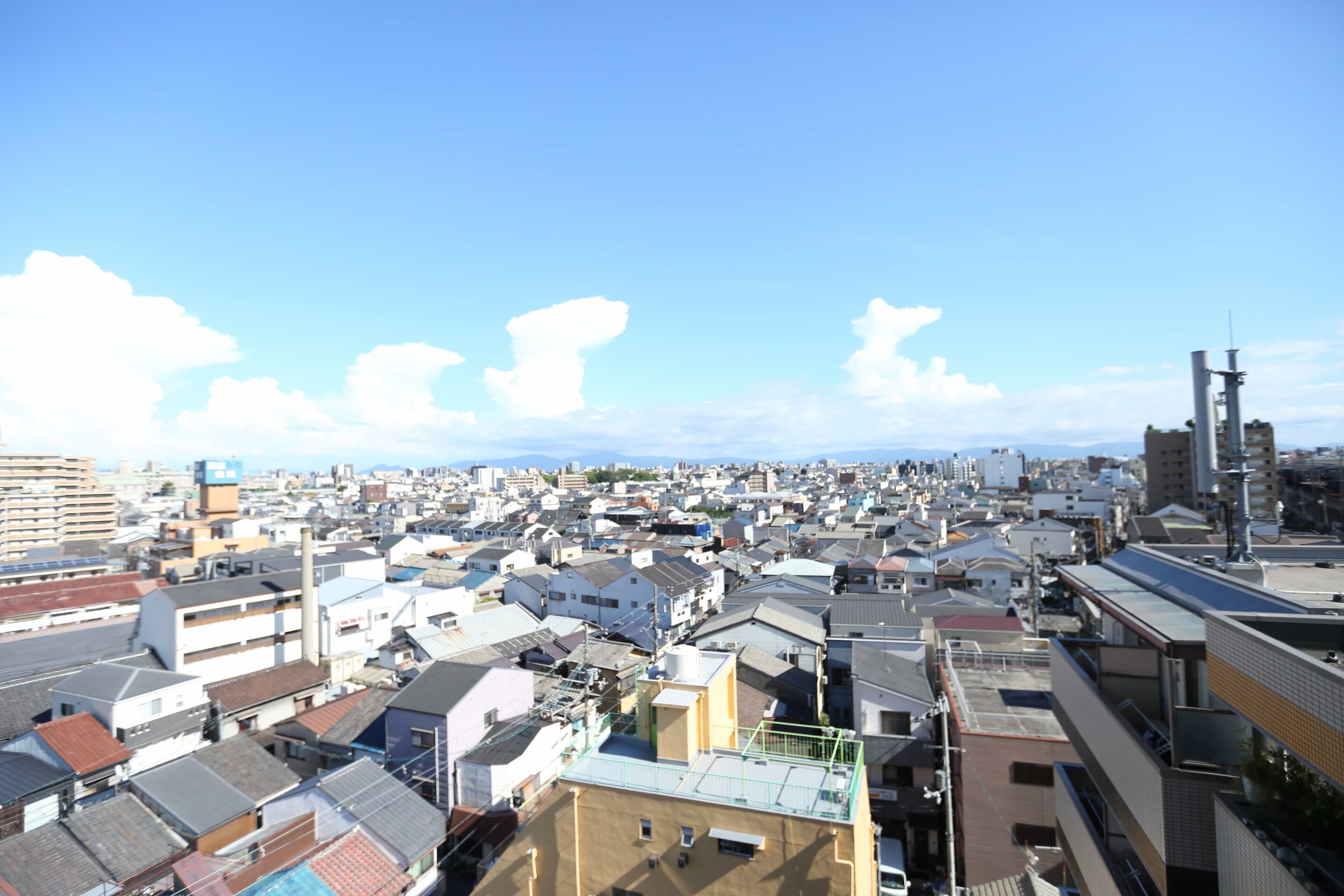 A densely packed urban area with numerous buildings and a clear sky.
