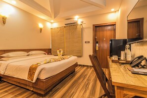 In-room safe, desk, laptop workspace, blackout curtains - Munal and Mayur Resort (Kalika)