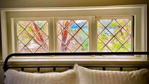 A bed with a headboard against a window with three panes. - Heart of Eastsound-For couples! (Eastsound)