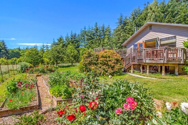 Goldeneye Farm with gardens, decks, and lush island grounds.
