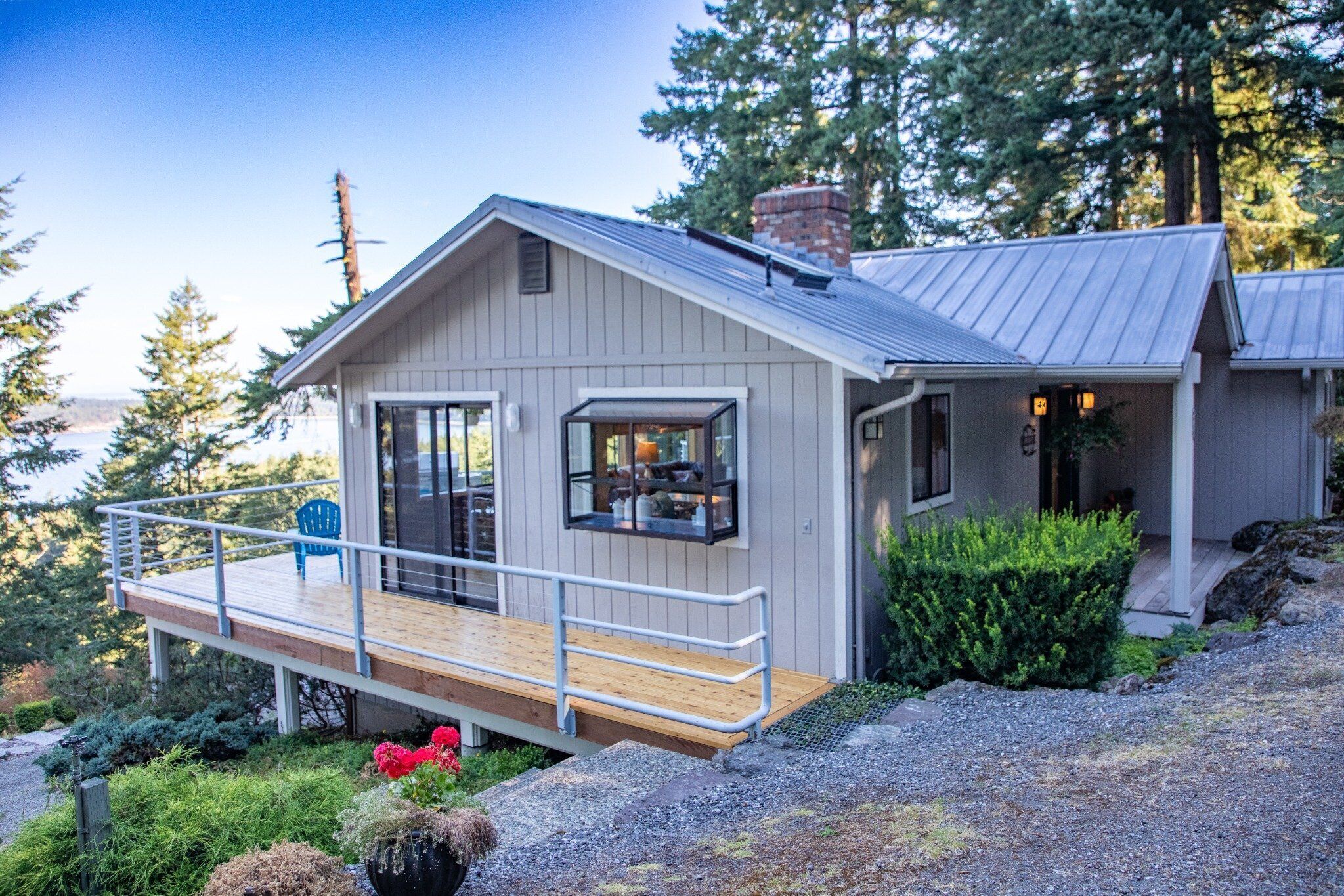 Elevated island home with wraparound decks, forest setting and scenic views. 