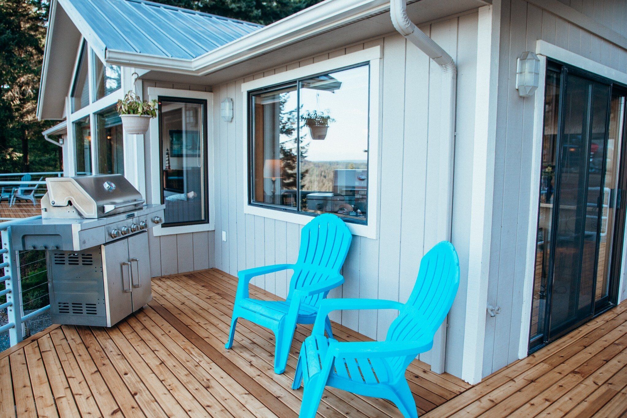Deck with gas BBQ, seating, and direct access from the main living area.