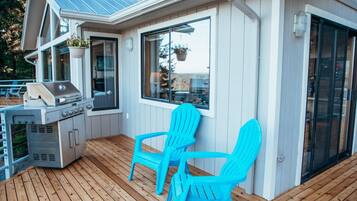 Deck with gas BBQ, seating, and direct access from the main living area.