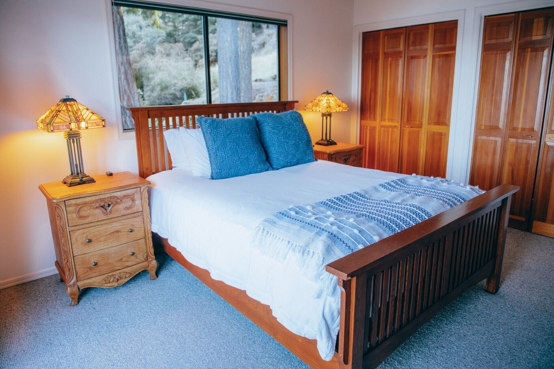 Upstairs master with balcony, ensuite bath, and peaceful forest/water views.