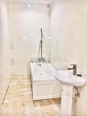 Combined shower/bathtub, towels, soap, toilet paper - Omega Homes Guesthouse  Lifecamp Abuja (Abuja)
