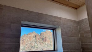 A bathroom with a window overlooking a rocky landscape. - Ten Bits Ranch - Room #19 Lewis Land & Cattle Co. (Terlingua)